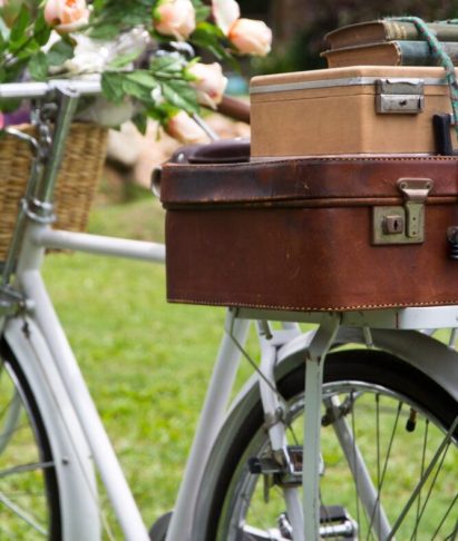 Vintage bicycle on the field with a bag